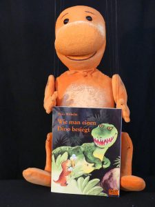 Dino-Puppe mit Buch
